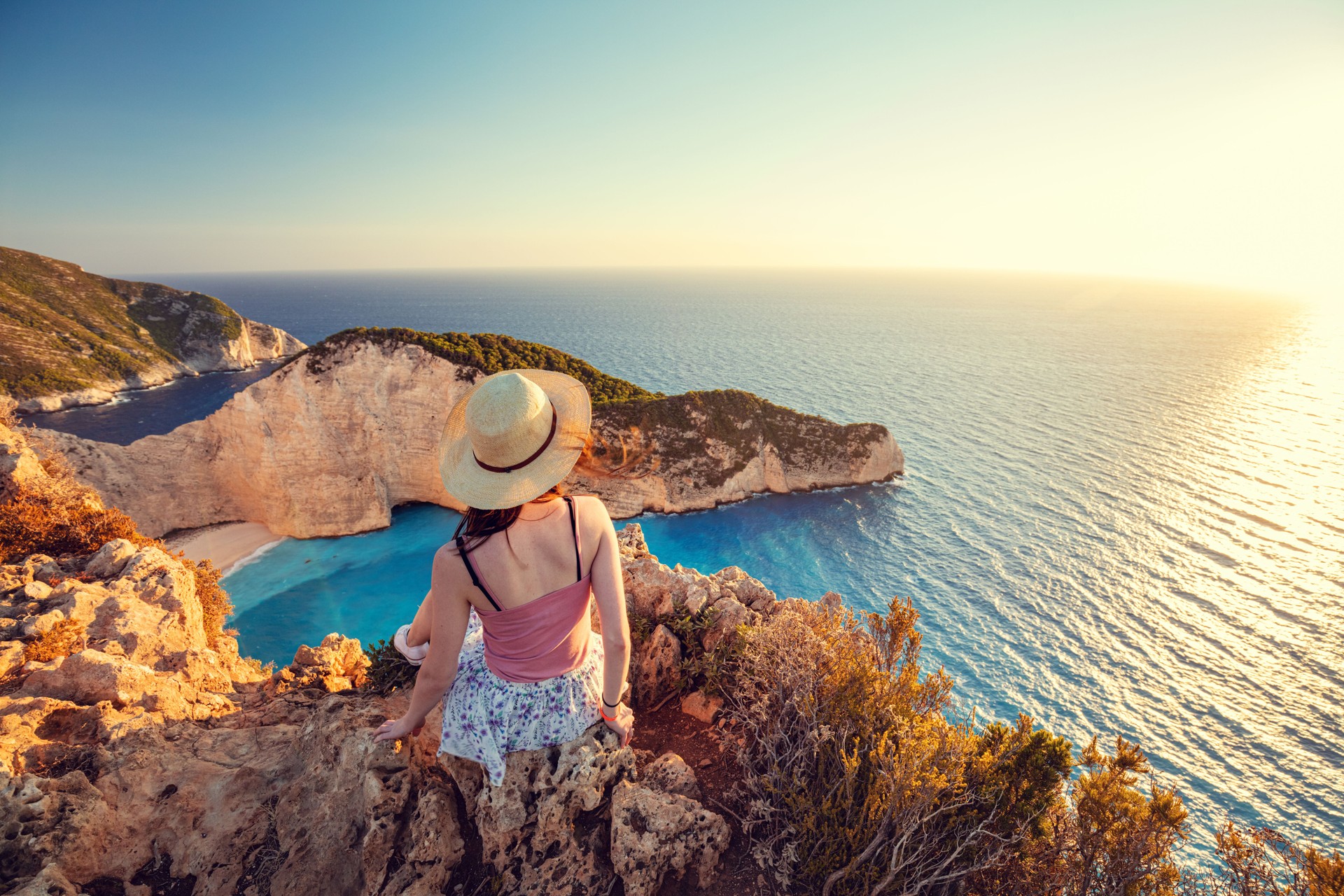 Woman tourist in Zakynthos, Greece admiring the Navagio beach