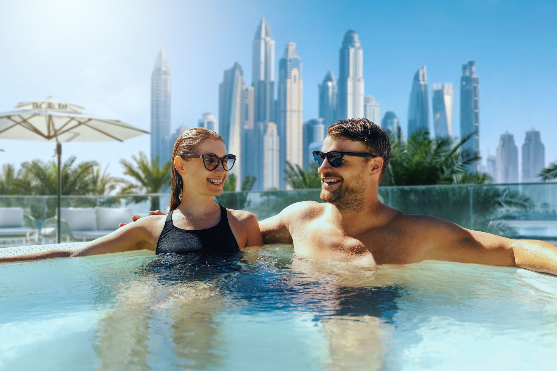 happy young couple relaxing in outdoor hot tub. luxury vacation, getaway travel